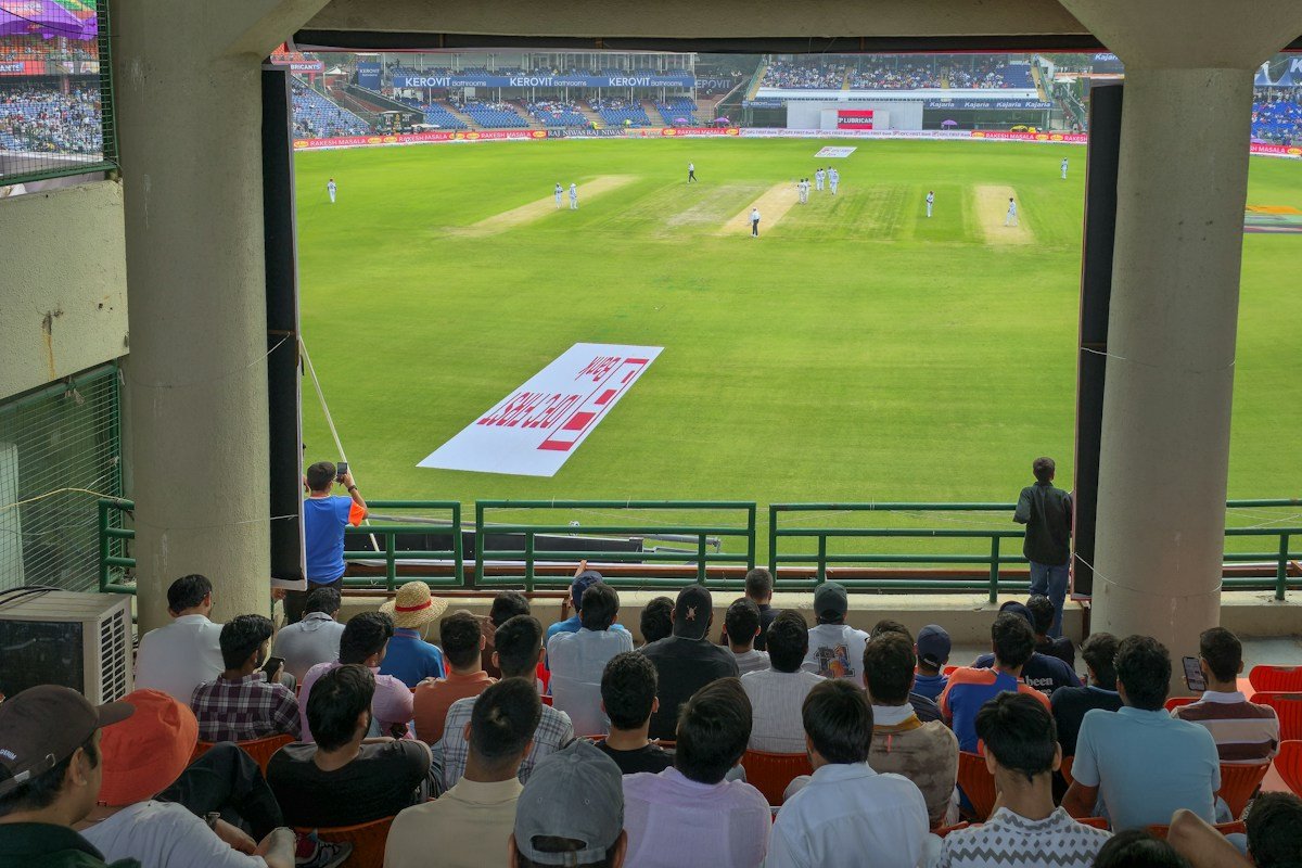 Spectators watch a live cricket match at an Indian stadium